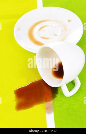 Overturned cup of coffee on table close-up Stock Photo