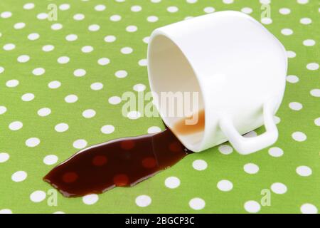 Overturned cup of coffee on table close-up Stock Photo