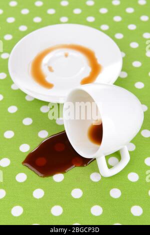 Overturned cup of coffee on table close-up Stock Photo