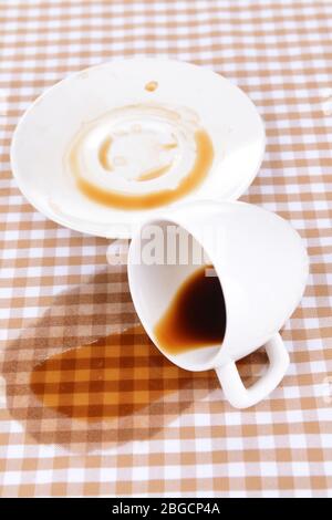 Overturned cup of coffee on table close-up Stock Photo
