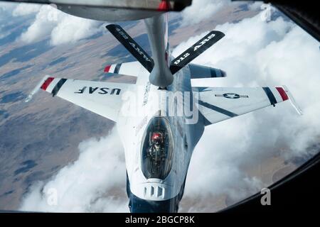 A U.S. Thunderbird F-16 Falcon refuels from the boom of a KC-135 Stratotanker over Colorado on April 18, 2020. The 912th ARS provided in-air refuel support to the U.S. Air Force Thunderbirds for their U.S. Air Force Academy graduation flyover. (US Air Force photo by Tech. Sgt. Nick Kibbey) Stock Photo