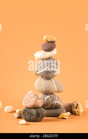 Tower of sea natural stones on a brown background. Stock Photo