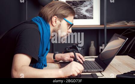 Photographer processing images, side view Stock Photo