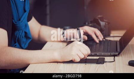 Photographer hands using digital devices Stock Photo