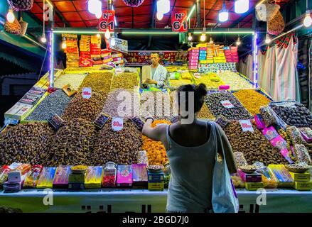 Street food vendor at night in Jemaa el-Fnaa,Djema el-Fna or Djemaa el-Fnaa  market square.Dried fruits and seeds vendor. Stock Photo