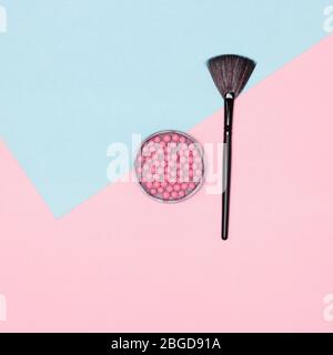 Makeup blush with make-up brush flatlay on pink and blue pastel background Stock Photo