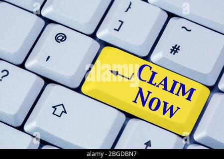 A keyboard with the words CLAIM NOW in blue lettering on a yellow enter key. Insurance, winning or pension concept. England, UK, Britain Stock Photo