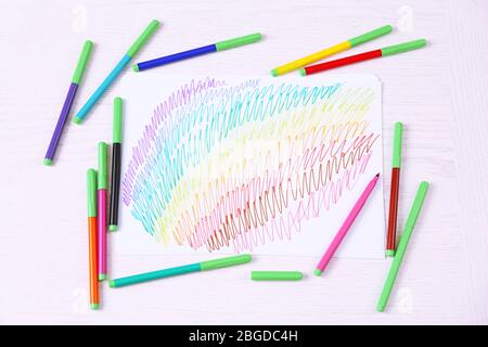 Kids drawing of family and colored pencils on wooden table Stock Photo -  Alamy