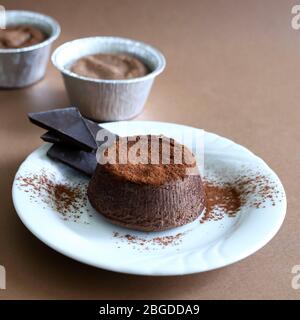 Dessert food concept. Chocolate cake on brown background. Top view, copy space.