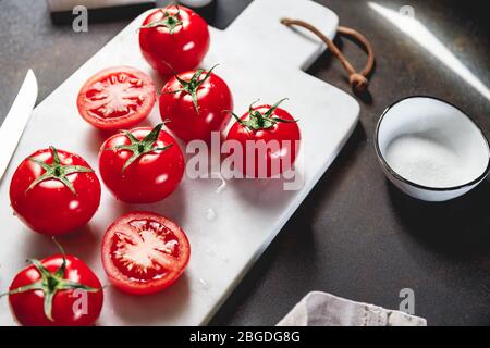 Cherry tomatoes on a white marble tray. Stock Photo