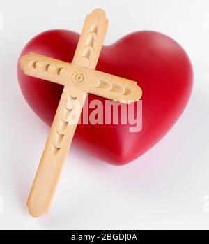 Heart with wooden cross isolated on white Stock Photo