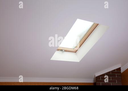 Roof skylight in new modern attic room Stock Photo