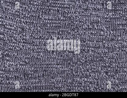 Texture of knitted fabric. Cold weather background. Warm black and white wool sweater texture. Knitted fabric background. Stock Photo