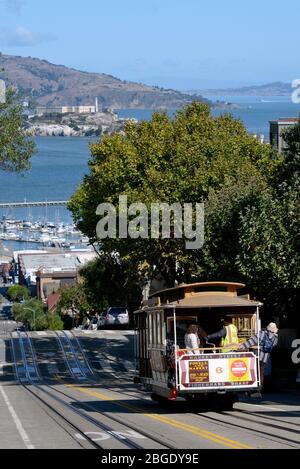 Cable Car on Hyde Street, in the background the prison island Alcatraz, San Francisco, California, USA