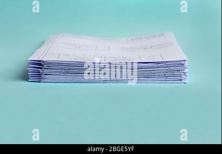 Stack Folding drawings on a blue background. Copy space. Stock Photo