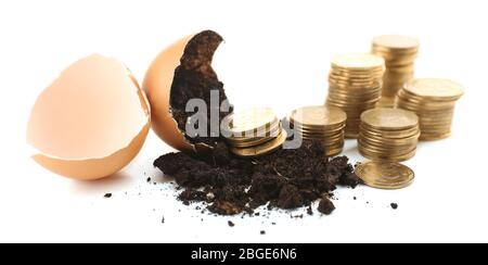 Coins and eggshell with soil isolated on white Stock Photo