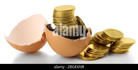 Coins in eggshell isolated on white Stock Photo