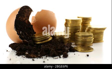 Coins and eggshell with soil isolated on white Stock Photo