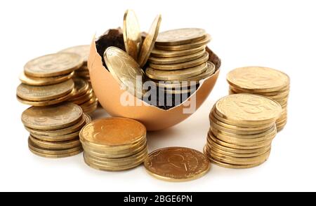 Coins in eggshell isolated on white Stock Photo