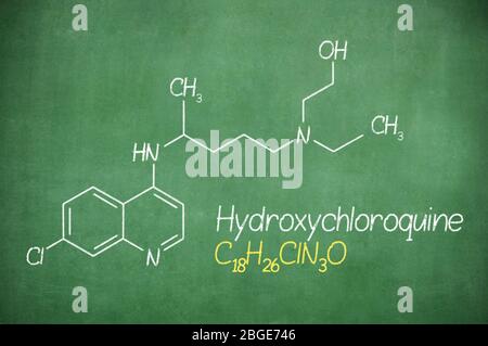 Hydroxychloroquine formula, medicine substance. Drug used in treatment for coronavirus SARS-CoV-2. Active in COVID-19 therapy. Chalk on board. Stock Photo