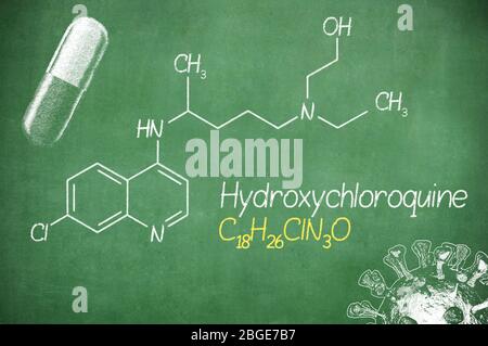 Hydroxychloroquine formula, medicine substance. Drug used in treatment for coronavirus SARS-CoV-2. Active in COVID-19 therapy. Chalk on board. Stock Photo