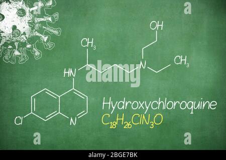 Hydroxychloroquine formula, medicine substance. Drug used in treatment for coronavirus SARS-CoV-2. Active in COVID-19 therapy. Chalk on board. Stock Photo