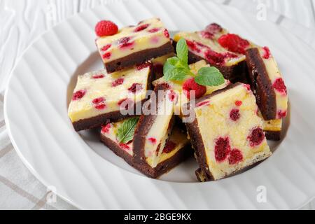 delicious vegetarian Raspberry Cheesecake Bars on a white plate, horizontal view from above Stock Photo