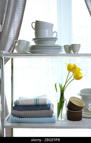 Different tableware on shelf in the interior Stock Photo