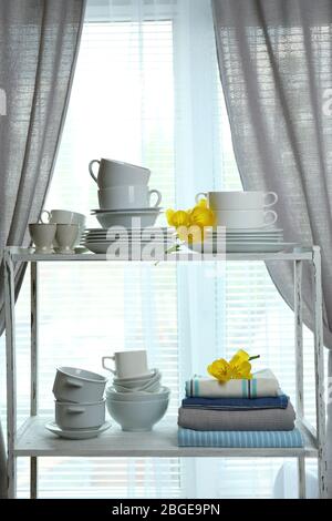 Different tableware on shelf in the interior Stock Photo