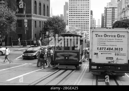 San Francisco street car Van Ness Avenue California Market Street boarding people person cable car old style type high-rise track bridge Golden Gate Stock Photo