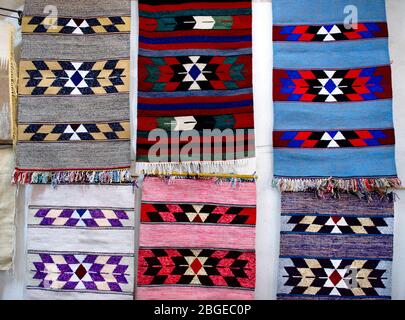 Seamless pattern design with traditional jordan motif.Colorful handmade woolen bedouin rugs, Petra, Jordan. Handcrafts isolaied on rock stones backgro Stock Photo