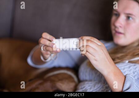 teen holding gaming controller Stock Photo
