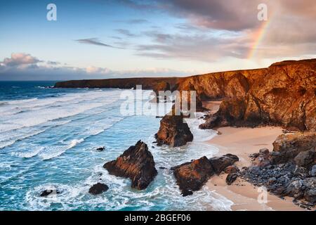 Evening rainbow over Bedruthan Steps Stock Photo