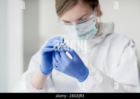 Tube with coronavirus in doctor's hand