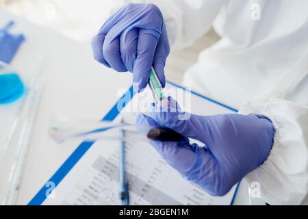 Test for coronavirus in hands of unrecognizable technician Stock Photo
