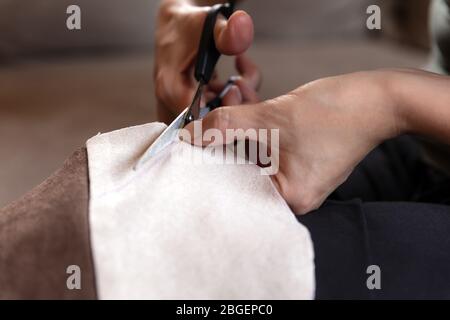 Process of homemade fabric cloth face mask for corona or covid-19 virus, cutting with scissors Stock Photo