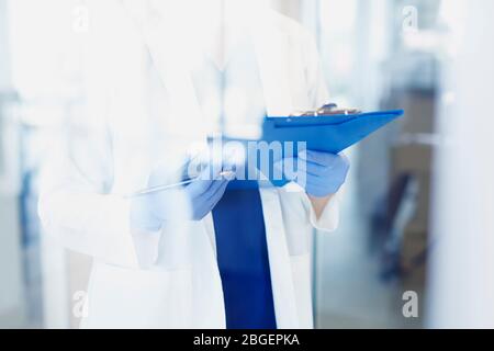 Doctor in apron behind the glass Stock Photo