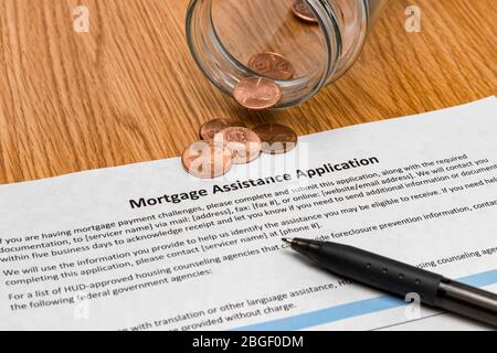 Mortgage assistance application , empty savings jar and coins. Concept of unemployment, recession and debt during Covid-19 coronavirus pandemic Stock Photo