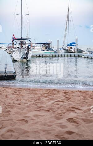 CHON BURI, THAILAND - FEBRUARY 16, 2019: Eye view the small yacht club in Pattaya. The yacht, sail mooring, parking at the pier on Pattaya beach.Thail Stock Photo