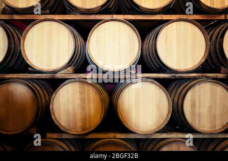 Old historic wine cellar in Langhe (Piedmont, Italy) with wooden barriques stacked Stock Photo