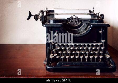 old mechanical typewriter on a wooden table Stock Photo