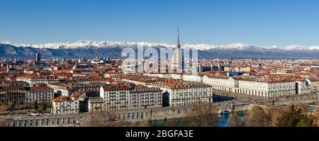Winter panorama of Turin (Piedmont, Italy), with the Mole Antonelliana, Vittorio Veneto square and snowy mountains on the background Stock Photo