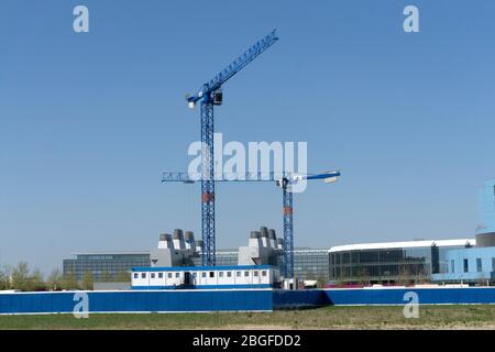 construction cranes on addenbrookes science park biomedical campus Cambridge MRC LMB laboratory of molecular biology in background Stock Photo