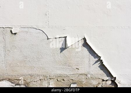 White paint peeling off of a wall closeup Stock Photo