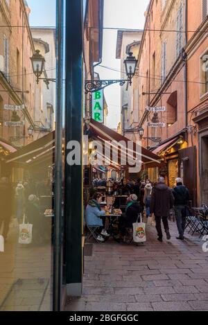 Via Pescherie Vecchie in the centre of Bologna, Italy, a narrow street with lots of restaurants and food shops in the old Market Il Quadrilatero. Stock Photo