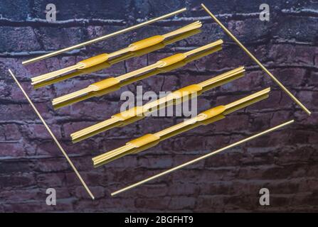 Spaghetti fed through penne pasta and framed on reflective surface Stock Photo