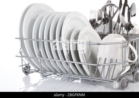 Clean dishes drying on metal dish rack, isolated on white Stock Photo