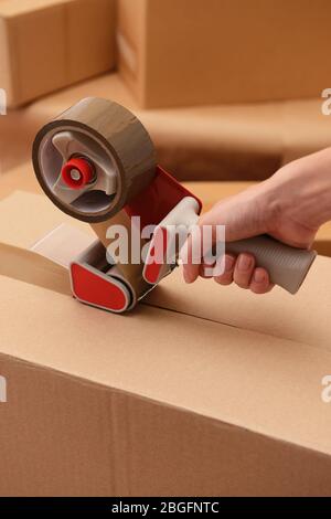 Packaging parcels with dispenser close-up Stock Photo