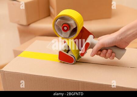 Packaging parcels with dispenser close-up Stock Photo