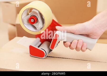 Packaging parcels with dispenser close-up Stock Photo